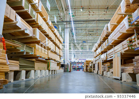 racks with wooden boards and slabs in the warehouse of the hardware store. racks with wooden boards and slabs in the warehouse of the hardware store. 93337446