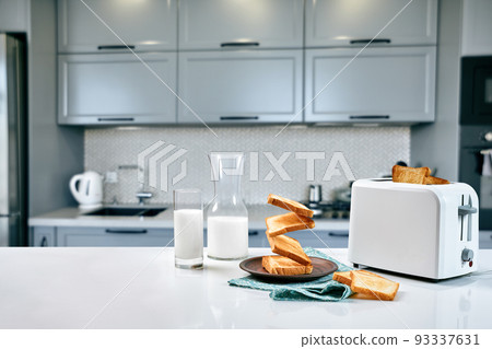 Served table for breakfast with toast, milk and honey, on blurred background 93337631