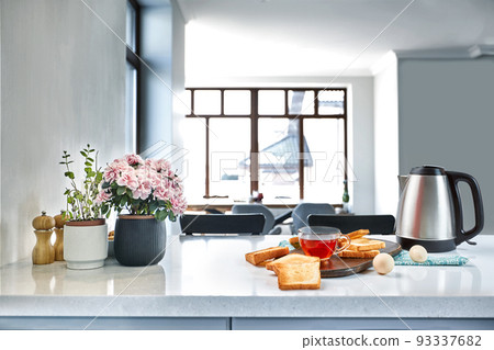 A cup of black tea with Sandwiches or toasts on white table. A cup of black tea with Sandwiches or toasts on white table. 93337682