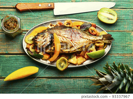Baked fish with pineapple, mango and kiwi. Baked fish with pineapple, mango and kiwi. 93337967