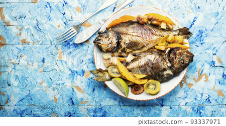 Baked fish with pineapple, mango and kiwi. Baked fish with pineapple, mango and kiwi. 93337971