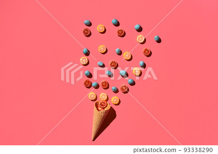 A variety of delicious sweets explode from the waffle cone, view from above. From left to the right direction 93338290