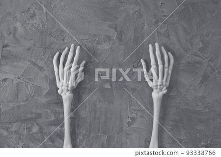 Mystery Halloween flat lay with white monster skeleton hands on dark gray background. Happy Halloween banner mock-up. Top view, copy space 93338766