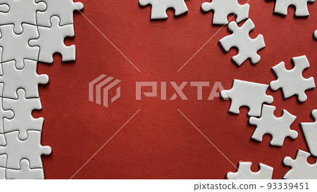 Jigsaw puzzle on red background with customizable space for text or ideas. Copy space Jigsaw puzzle on red background with customizable space for text or ideas. Copy space 93339451
