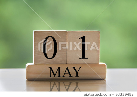May 1 calendar date text on wooden blocks with blurred nature background. Copy space and calendar concept 93339492