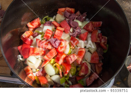 Metal stock pot with soup ingredients vegetables and meat Metal stock pot with soup ingredients vegetables and meat 93339751