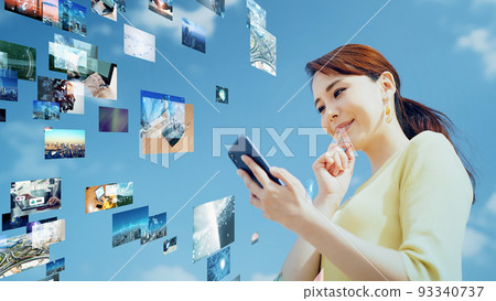 A woman watching video on a smartphone A woman watching video on a smartphone 93340737