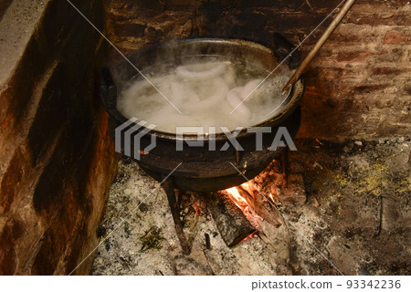 Cooking white blood sausage, in an iron saucepan, on a stove. Cooking white blood sausage, in an iron saucepan, on a stove. 93342236