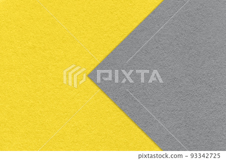 Texture of yellow paper background, half two colors with gray arrow, macro. Structure of dense craft cardboard. 93342725