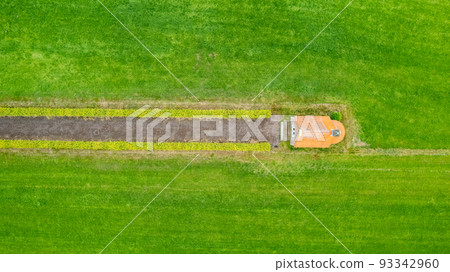 garden detail in aerial view with sand path going between two hedges towards a little building, a garden detail in aerial view with sand path going between two hedges towards a little building, a 93342960