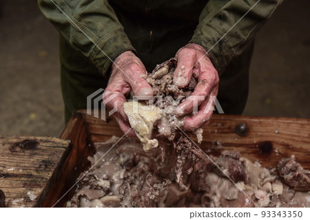 Hands mixing ingredients to stuff white sausage, Argentina Hands mixing ingredients to stuff white sausage, Argentina 93343350