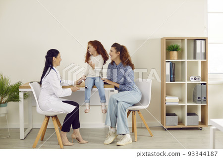 Doctor neuropathologist with special hammer checks knee reflexes on leg of little girl. Doctor neuropathologist with special hammer checks knee reflexes on leg of little girl. 93344187