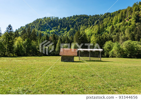 Old Wooden Barn and Hay Rack on a Green Meadow - Alps Slovenia 93344656