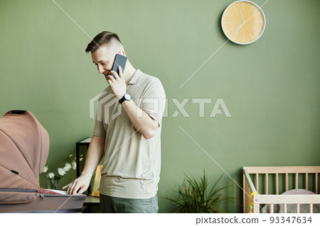 Happy young dad babysitting with his baby 93347634