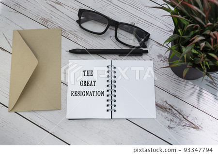 THE GREAT RESIGNATION text on notepad with brown envelop on wooden table. THE GREAT RESIGNATION text on notepad with brown envelop on wooden table. 93347794