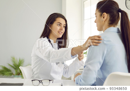 Supportive doctor reassuring young woman during medical consultation at her office Supportive doctor reassuring young woman during medical consultation at her office 93348650