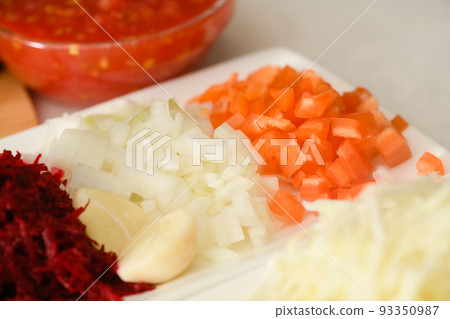 Close-up of chopped carrots and onions for making traditional Ukrainian borscht. Close-up of chopped carrots and onions for making traditional Ukrainian borscht. 93350987