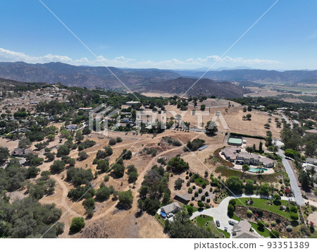 Aerial view of dry valley with houses and barn in Escondido, California 93351389