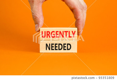 Urgently needed symbol. Concept words Urgently needed on wooden blocks on a beautiful orange table orange background. Businessman hand. Business and urgently needed concept. Copy space. 93351809