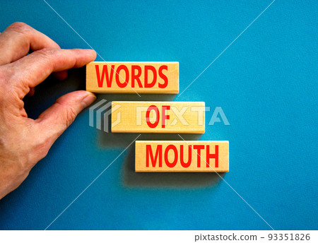 Words of mouth symbol. Concept words Words of mouth on wooden blocks on a beautiful blue table blue background. Businessman hand. Business, finacial and words of mouth concept. Copy space. 93351826