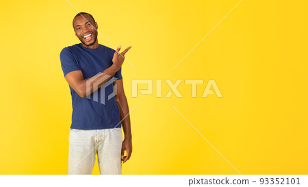 African Man Pointing Finger Aside At Empty Space, Yellow Background African Man Pointing Finger Aside At Empty Space, Yellow Background 93352101