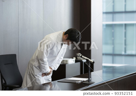 Male doctor in white coat giving an apology press conference Male doctor in white coat giving an apology press conference 93352151