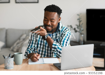 African Male Talking Holding Smartphone Using Voice Search At Home African Male Talking Holding Smartphone Using Voice Search At Home 93352198