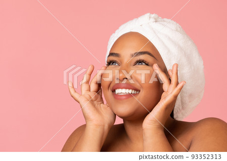 Happy African American Woman Moisturizing Face Skin Over Pink Background Happy African American Woman Moisturizing Face Skin Over Pink Background 93352313