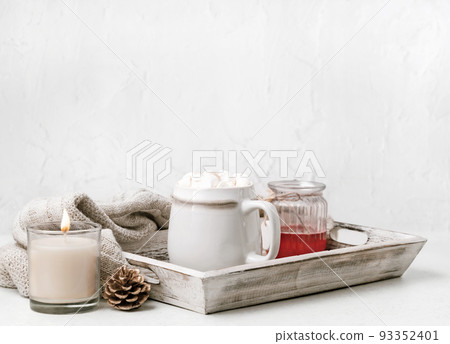 Cocoa or coffee cup with marshmallow on wooden tray. Christmas and new year holiday concept. Cozy winter home background. Cocoa or coffee cup with marshmallow on wooden tray. Christmas and new year holiday concept. Cozy winter home background. 93352401