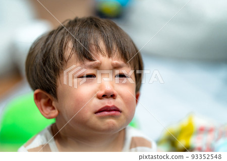 A boy in the unpleasant period crying loudly 93352548