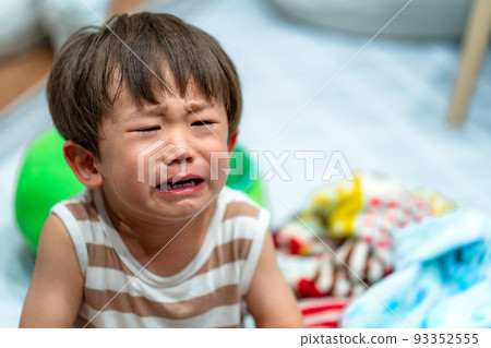 A boy in the unpleasant period crying loudly 93352555
