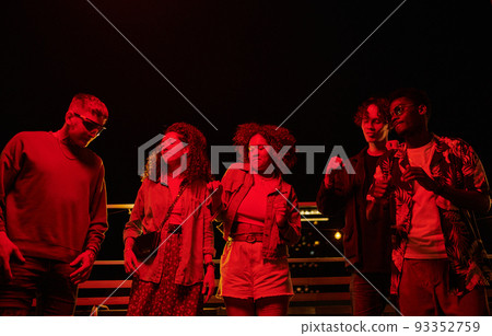 Group of happy young intercultural friends dancing during rooftop party 93352759