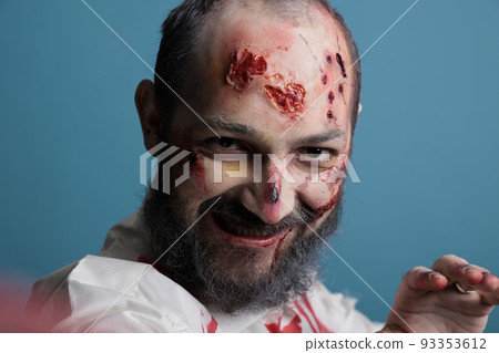 Scary deadly monster taking photo on mobile phone, having bloody scars and looking aggressive. Brain eating spooky zombie take picture on smartphone, frightening horror evil corpse. Scary deadly monster taking photo on mobile phone, having bloody scars and looking aggressive. Brain eating spooky zombie take picture on smartphone, frightening horror evil corpse. 93353612