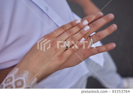 Newly wed couple's hands with wedding rings. Newly wed couple's hands with wedding rings. 93353764