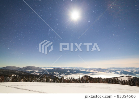 Magical winter landscape with snow covered tree. Vibrant night sky with stars and nebula and galaxy. Deep sky astrophoto. Magical winter landscape with snow covered tree. Vibrant night sky with stars and nebula and galaxy. Deep sky astrophoto. 93354506