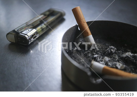 Cigarette butts in ashtray, disposable lighter Cigarette butts in ashtray, disposable lighter 93355419