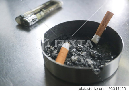 Cigarette butts in ashtray, disposable lighter Cigarette butts in ashtray, disposable lighter 93355423