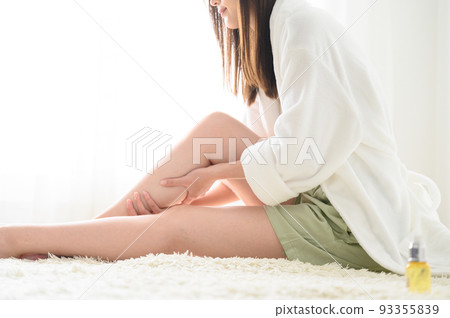 A woman who massages her feet and treats hair loss, no face 93355839