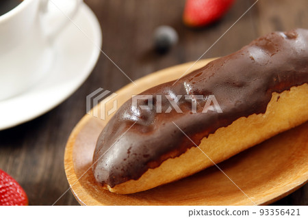 A cake-like eclair unsuitable for a diet with too much sugar on the table A cake-like eclair unsuitable for a diet with too much sugar on the table 93356421