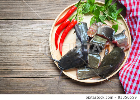 fresh raw catfish menu freshwater fish, catfish fillet on wooden plate, catfish for cooking food, fish chopped with ingredients herb and spices fresh raw catfish menu freshwater fish, catfish fillet on wooden plate, catfish for cooking food, fish chopped with ingredients herb and spices 93356559