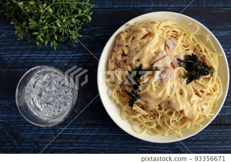 A large serving of pasta, spaghetti, and carbonara on the table 93356671