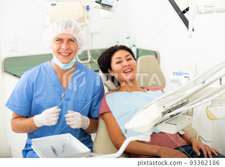 Woman is sitting satisfied in chair after treatment in dental clinic Woman is sitting satisfied in chair after treatment in dental clinic 93362186