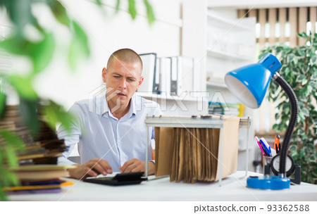 Office employee working with card index at workplace 93362588