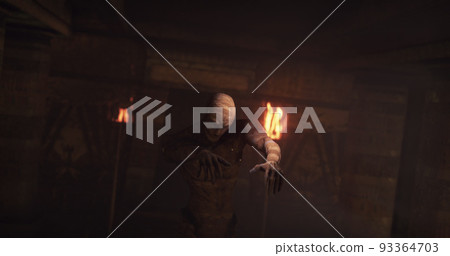 Image of scary zombie mummy walking around in dark crypt room with burning torches Image of scary zombie mummy walking around in dark crypt room with burning torches 93364703