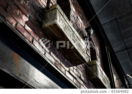 Graffiti with art letters on the exterior of the red brick building 93364992