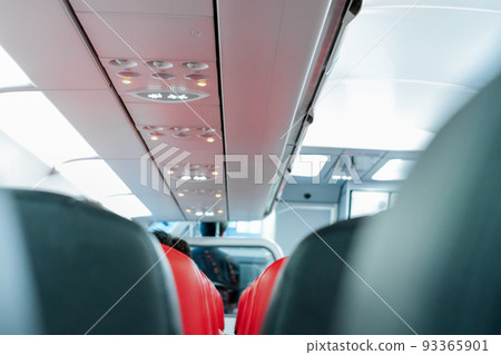 seats in the airplane and passenger sitting all area waiting for the plane taking off from runway. 93365901