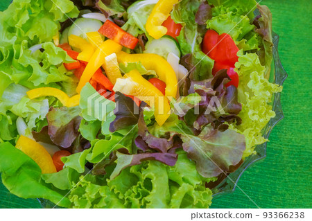 Mixed green red yellow and colourful vegetables slideed and arranged into bowl and wood basket bundle together ready for lunch or dinner. Mixed green red yellow and colourful vegetables slideed and arranged into bowl and wood basket bundle together ready for lunch or dinner. 93366238