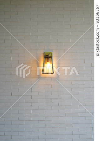 Square steel lamp tungsten/warm light on the white brick wall. 93366567