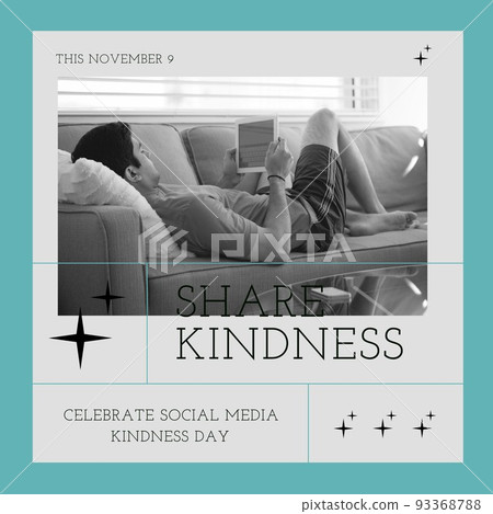 Young man using digital tablet while lying on couch with social media kindness day text in frame Young man using digital tablet while lying on couch with social media kindness day text in frame 93368788