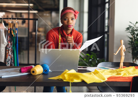 Portrait of confident african american fashion designer at desk in studio office 93369293